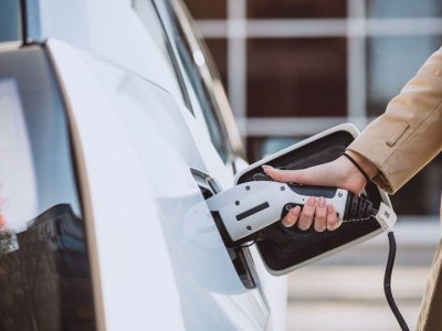 woman-charging-electro-car-electric-gas-station-scaled